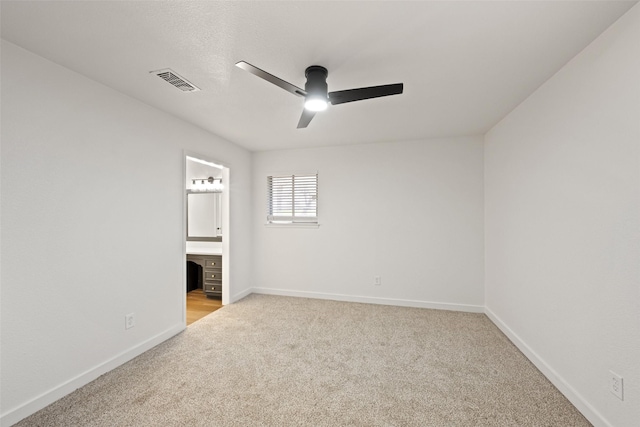 unfurnished room featuring light carpet and ceiling fan