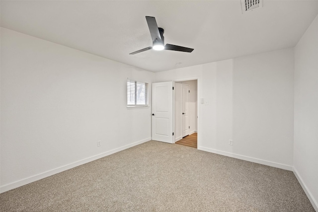 spare room with light carpet and ceiling fan