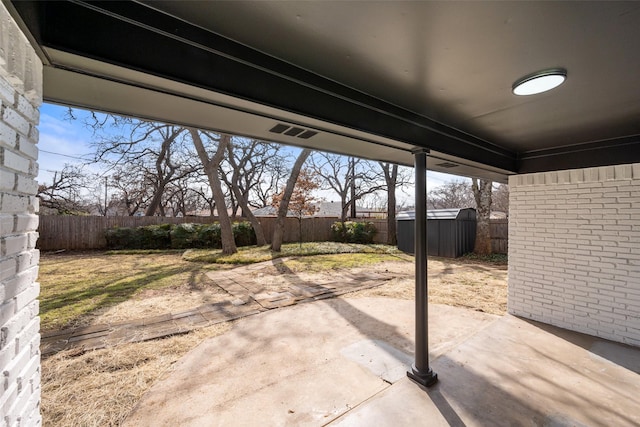 view of patio with a storage shed