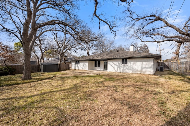 rear view of property featuring cooling unit, a yard, and a patio area