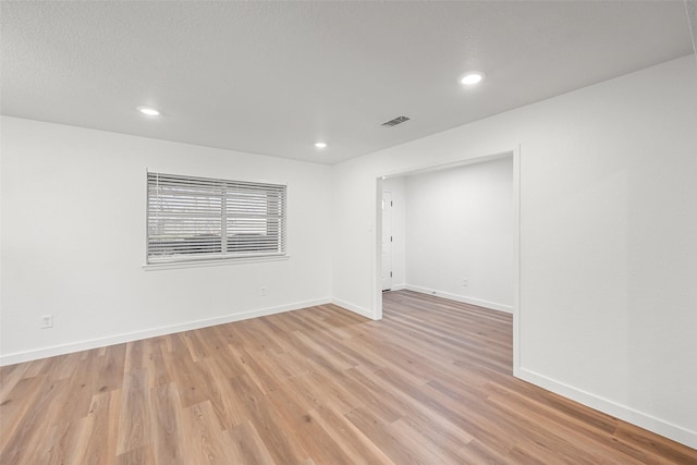 unfurnished room featuring light hardwood / wood-style floors