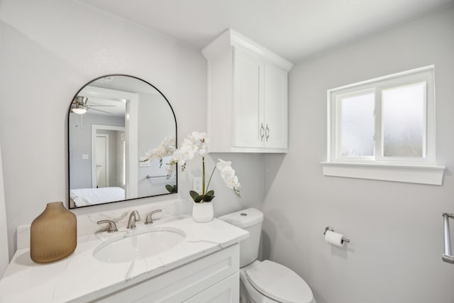 bathroom featuring ceiling fan, vanity, and toilet