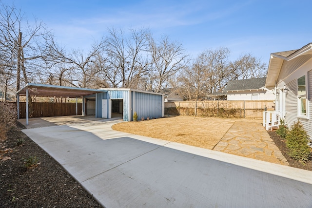 exterior space featuring a garage, an outdoor structure, and a carport