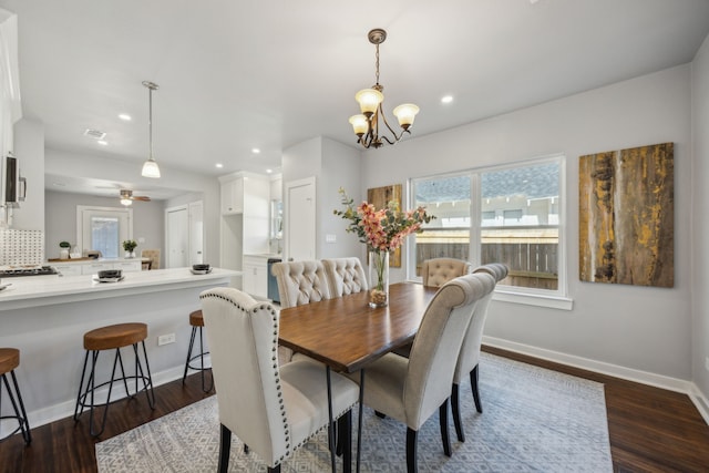 dining area featuring dark hardwood / wood-style flooring and a notable chandelier