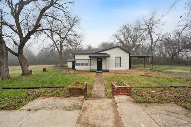 bungalow-style house featuring a carport and a front lawn