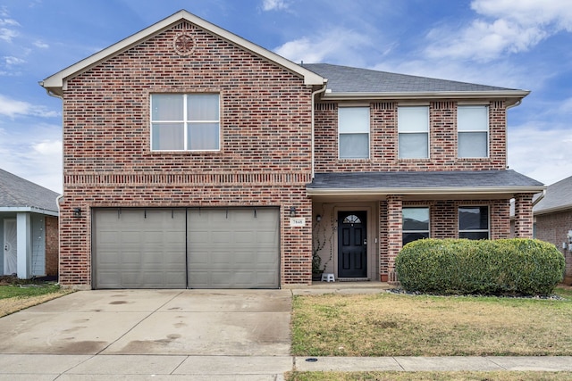 front facade featuring a garage and a front lawn