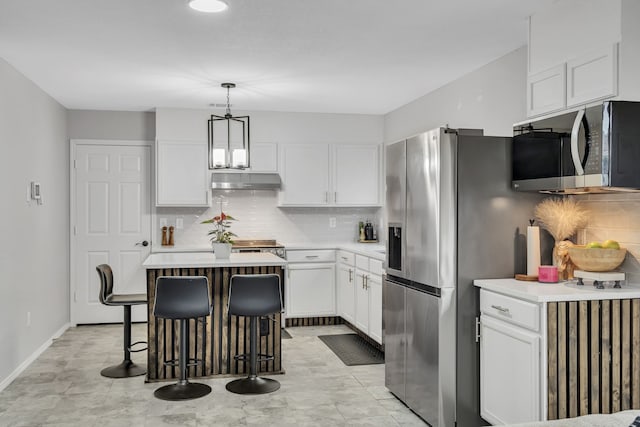 kitchen featuring pendant lighting, a center island, white cabinets, and appliances with stainless steel finishes