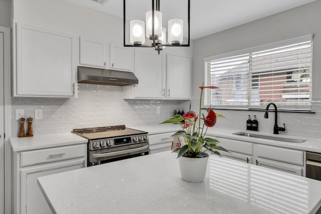 kitchen featuring hanging light fixtures, white cabinetry, sink, and electric stove