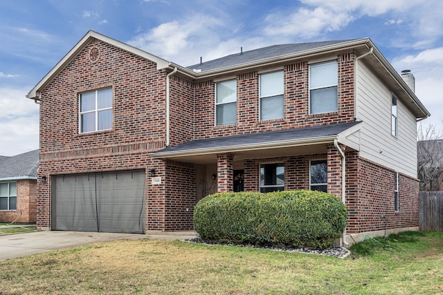 view of front of home featuring a garage and a front yard