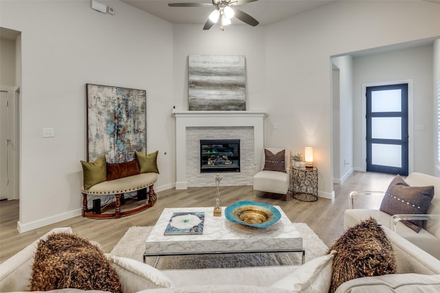 living room with ceiling fan and light wood-type flooring