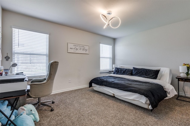 bedroom with carpet floors and baseboards