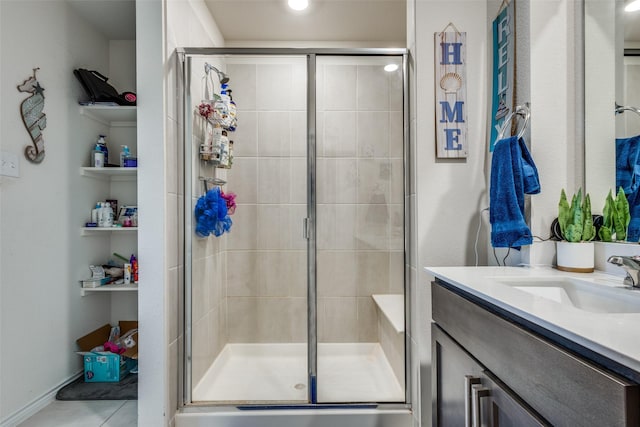 full bath with a stall shower, tile patterned flooring, and vanity