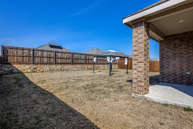 view of yard featuring a patio and a fenced backyard