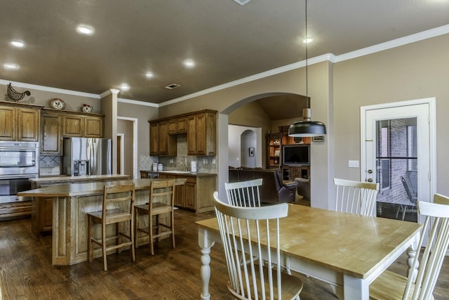 dining room featuring crown molding and dark hardwood / wood-style flooring