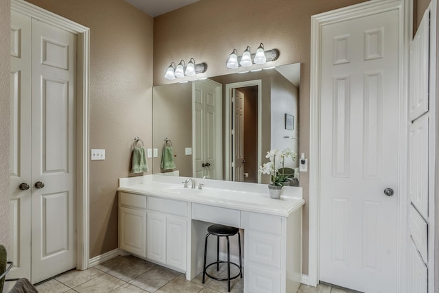 bathroom featuring tile patterned flooring and vanity