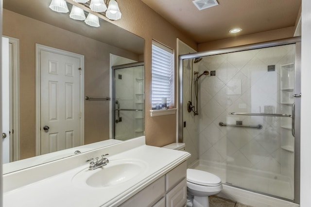 bathroom featuring walk in shower, vanity, and toilet