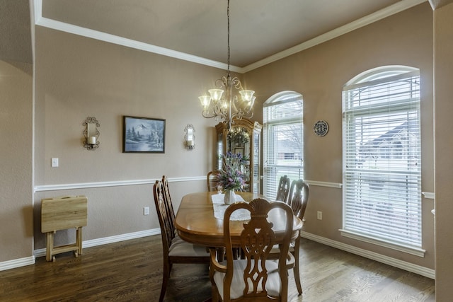 dining area featuring crown molding, an inviting chandelier, and dark wood-type flooring