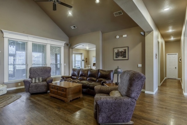 living room featuring ceiling fan, dark hardwood / wood-style flooring, and high vaulted ceiling