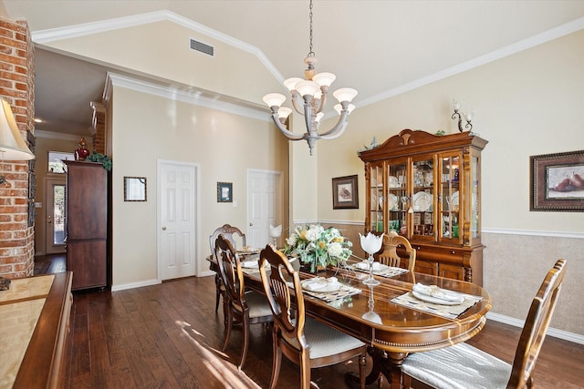 dining room with crown molding, vaulted ceiling, dark wood-type flooring, and a notable chandelier