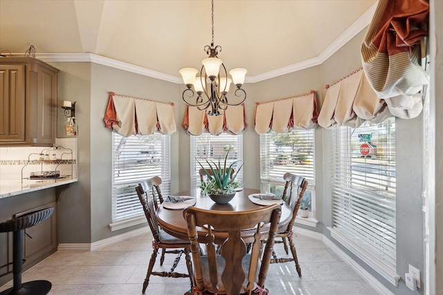 dining space with an inviting chandelier, crown molding, and light tile patterned flooring