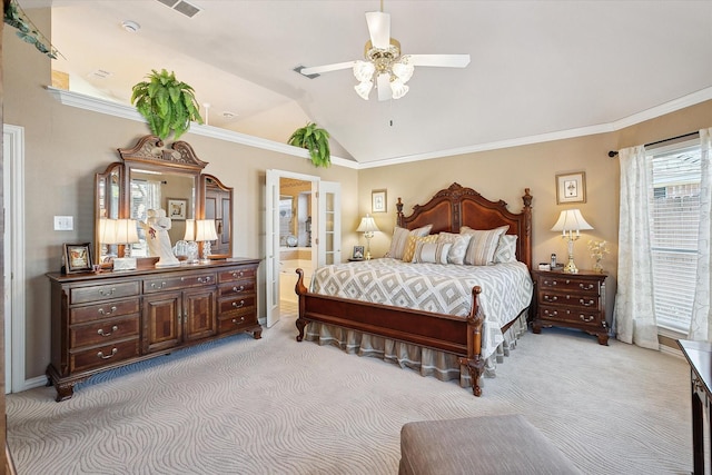 bedroom featuring lofted ceiling, connected bathroom, crown molding, and light carpet