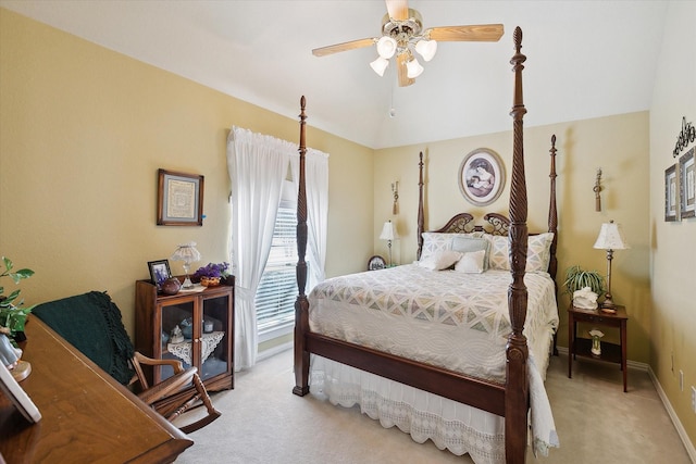 bedroom featuring vaulted ceiling, light colored carpet, and ceiling fan