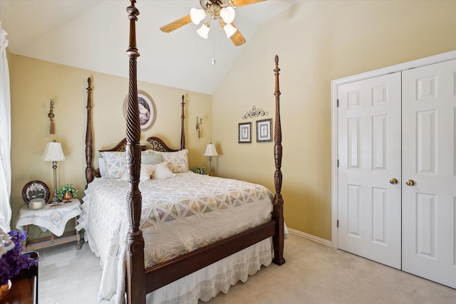 bedroom featuring vaulted ceiling, light colored carpet, ceiling fan, and a closet