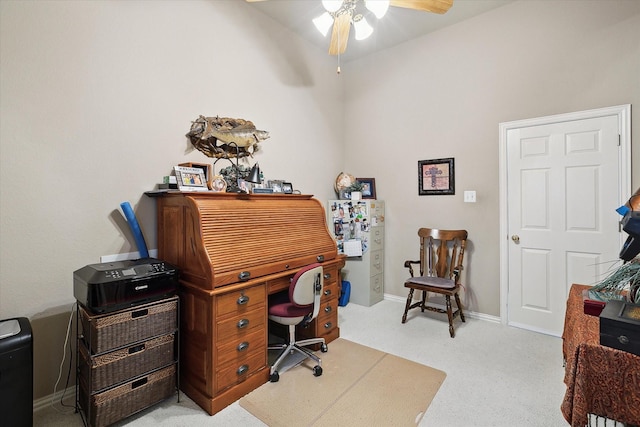 office space featuring light carpet and ceiling fan