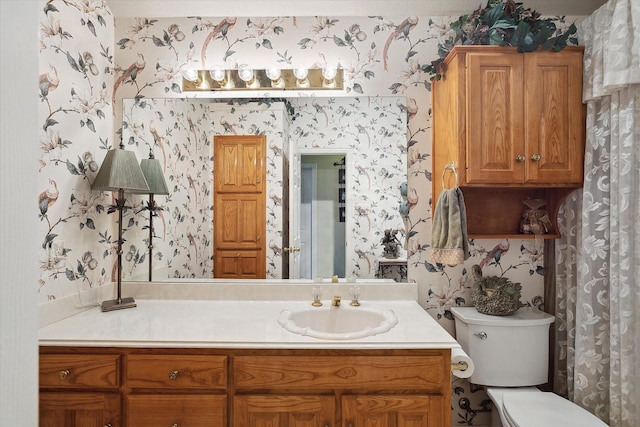 bathroom featuring vanity and toilet