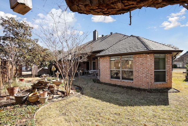 rear view of house with a yard