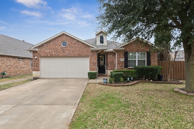 view of front of property featuring a garage and a front lawn