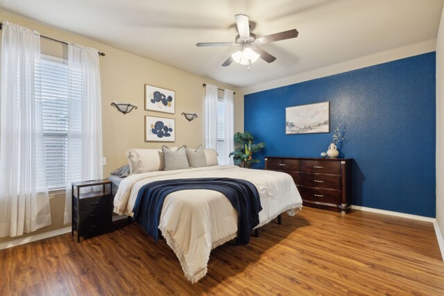 bedroom with ceiling fan, dark hardwood / wood-style floors, and a closet