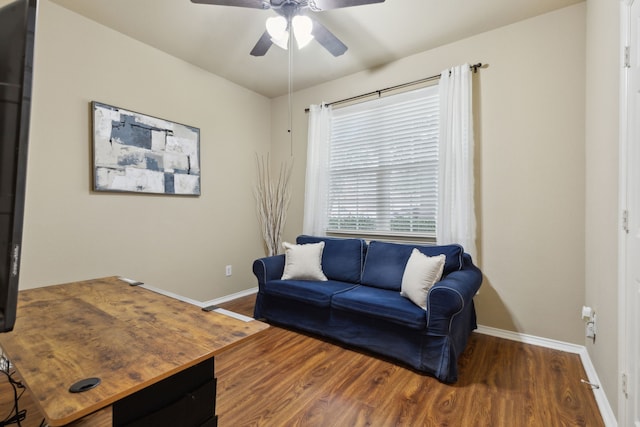 living room with ceiling fan and dark hardwood / wood-style floors