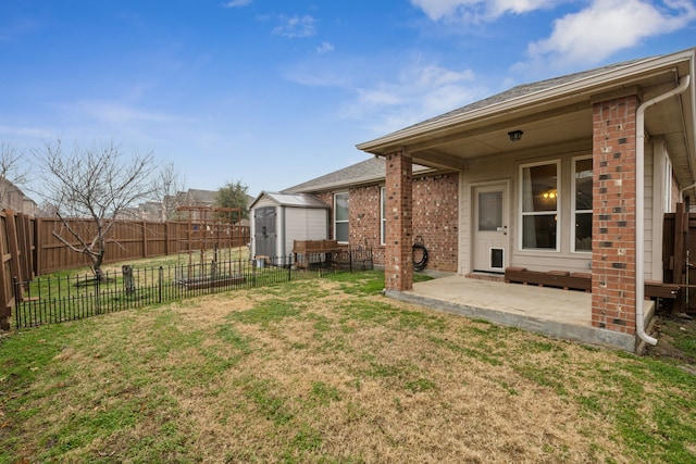 view of yard featuring a shed and a patio area