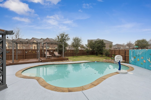 view of swimming pool featuring a wooden deck, a pergola, and a lawn