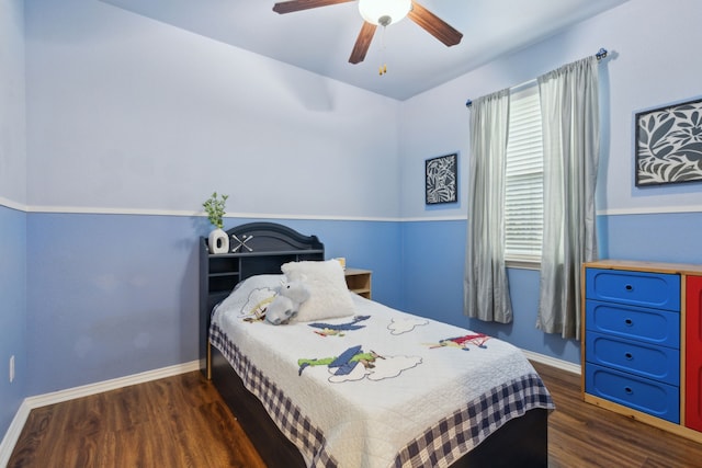 bedroom with ceiling fan, baseboards, and wood finished floors