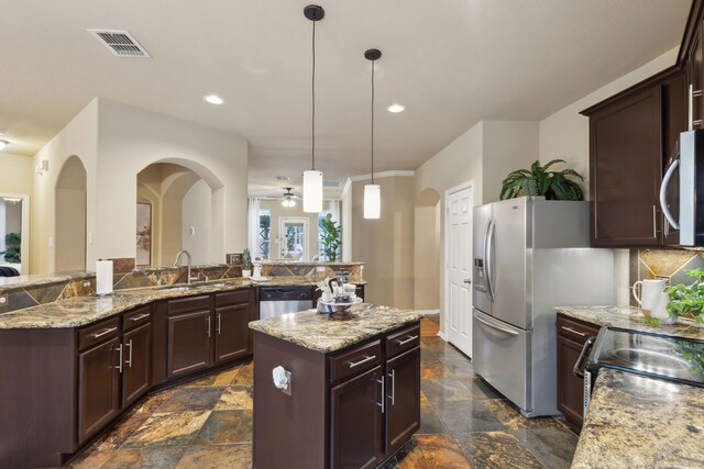 dining area with sink and ceiling fan