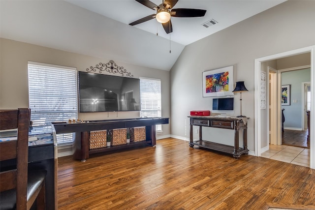 living room with lofted ceiling, hardwood / wood-style floors, and ceiling fan