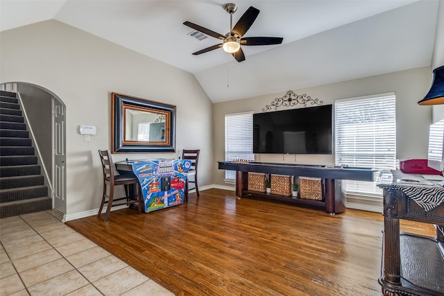 living room with lofted ceiling, hardwood / wood-style floors, and ceiling fan