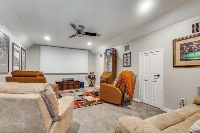 cinema room featuring vaulted ceiling, light colored carpet, and ceiling fan