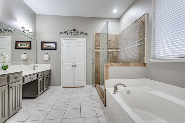 bathroom with tile patterned floors, vanity, and shower with separate bathtub