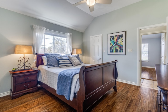 bedroom with lofted ceiling, dark wood-type flooring, and ceiling fan