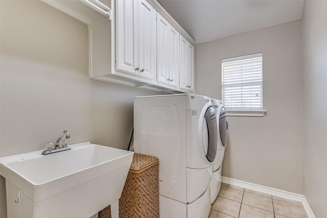 laundry room featuring light tile patterned flooring, independent washer and dryer, sink, and cabinets