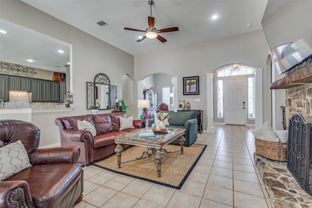 living room featuring light tile patterned floors and ceiling fan