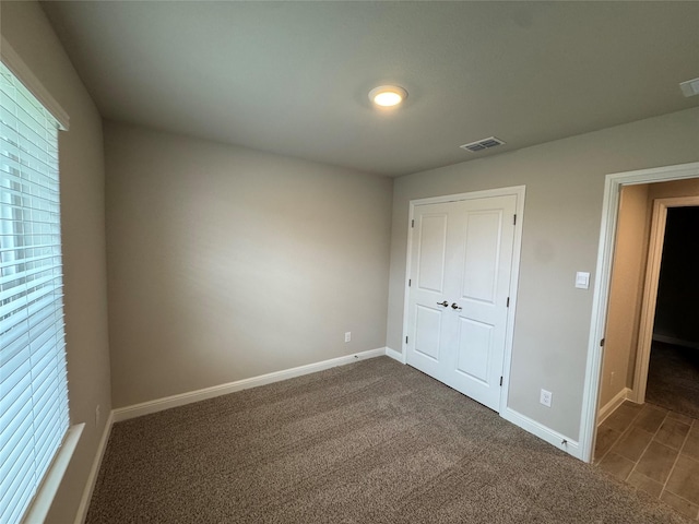 1744 River Bend Rd, Burleson, TX 76028 - unfurnished bedroom with baseboards, a closet, and dark colored carpet