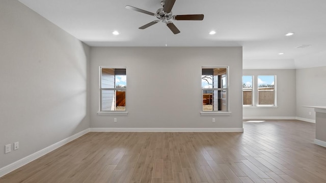 spare room with light hardwood / wood-style flooring and ceiling fan