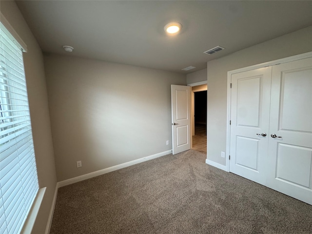 1744 River Bend Rd, Burleson, TX 76028 - unfurnished bedroom with carpet flooring, baseboards, and a closet
