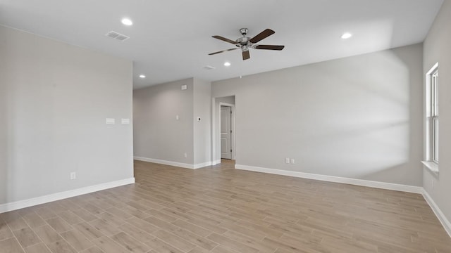 empty room featuring ceiling fan and light wood-type flooring