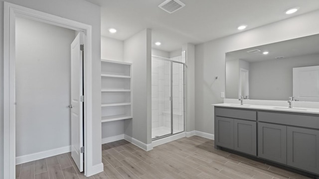 bathroom featuring vanity and an enclosed shower