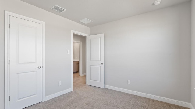 unfurnished bedroom with light carpet